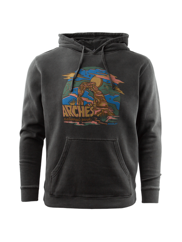 Washed black pullover hoodie with a colorful Arches National Park graphic of Delicate Arch under a blue sky with a golden sun, clouds and desert plants