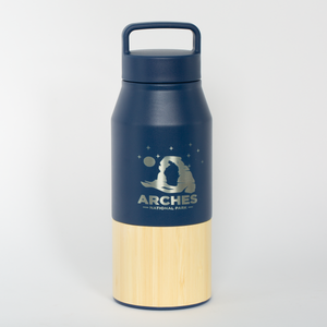 Navy and beige water bottle with Arches National Park logo on a light gray background
