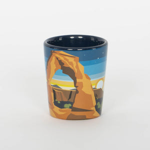 Ceramic mug with desert landscape design on a white background