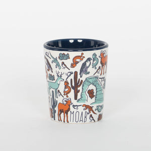 Ceramic mug with desert-themed illustrations and 'Moab' text on a white background