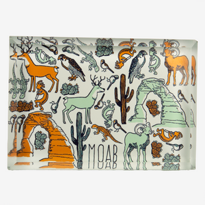 Glass with desert-themed design featuring animals and landscapes, with 'Moab' text.
