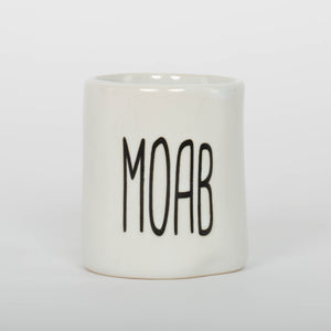 White mug with 'MOAB' printed on a white background