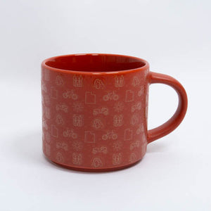 Red mug with white patterns on a white background