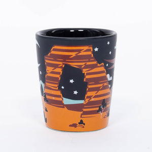 Ceramic mug with a design of a desert landscape featuring a camel, stars, and a moon on a white background.