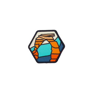 Atomicchild Delicate Arch Woven Patch, a small hexagon patch with a colorful Delicate Arch design