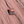 Canyonlands National Park enamel pin framing a sunrise through Mesa Arch, lying on red sandstone in Moab, Utah.