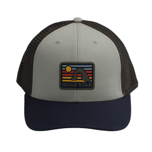Legacy Alpine Mid-Pro Snapback Hat in gray and navy with a Moab Utah mountain sunset patch, front view