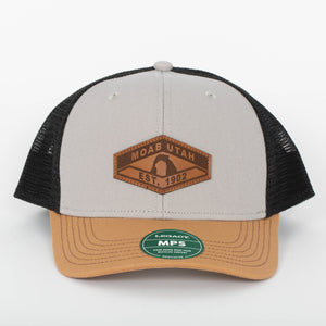 Legacy Mid Pro Snapback in grey, caramel and black, front view with a leather MOAB UTAH EST. 1902 Delicate Arch patch