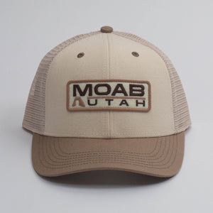 Legacy Stone Clay Mid-Pro Snapback Hat in tan and brown with a Moab Utah patch, front view