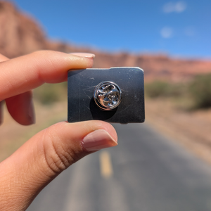 Back of the Moab trail sign lapel pin showing the rubber clutch.