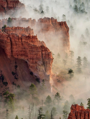 National Geographic Atlas of the National Parks open to a misty red rock hoodoos photo spread