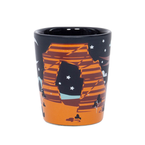 Smith-Western Nord Shot Glass, a black shot glass with an orange Delicate Arch under a crescent moon and stars
