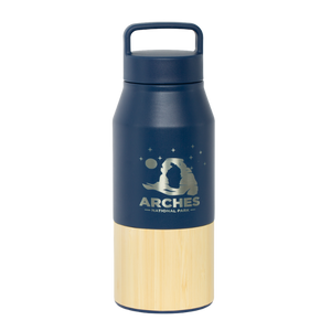 Welly Arches Navy Traveler Water Bottle, a navy insulated bottle with a bamboo base and a Delicate Arch night sky graphic